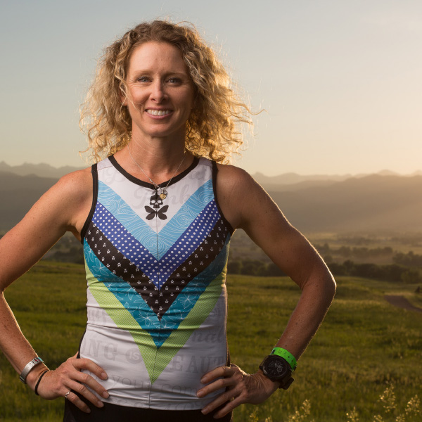 Portrait of a Professional Iron Woman smiling against Colorado mountain landscape
